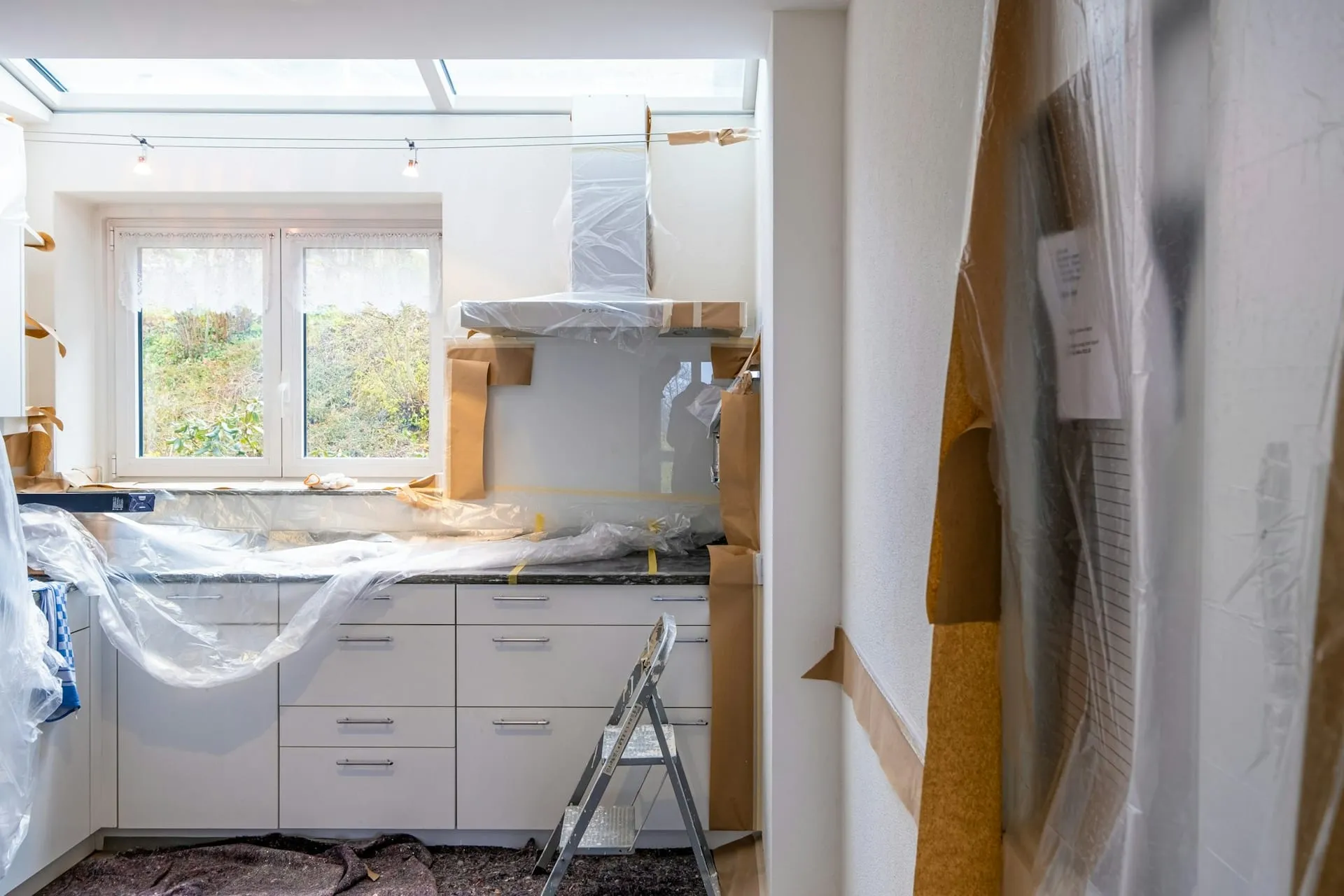 Kitchen covered in protective sheeting after renovation GK Cleaning Solutions Brighton