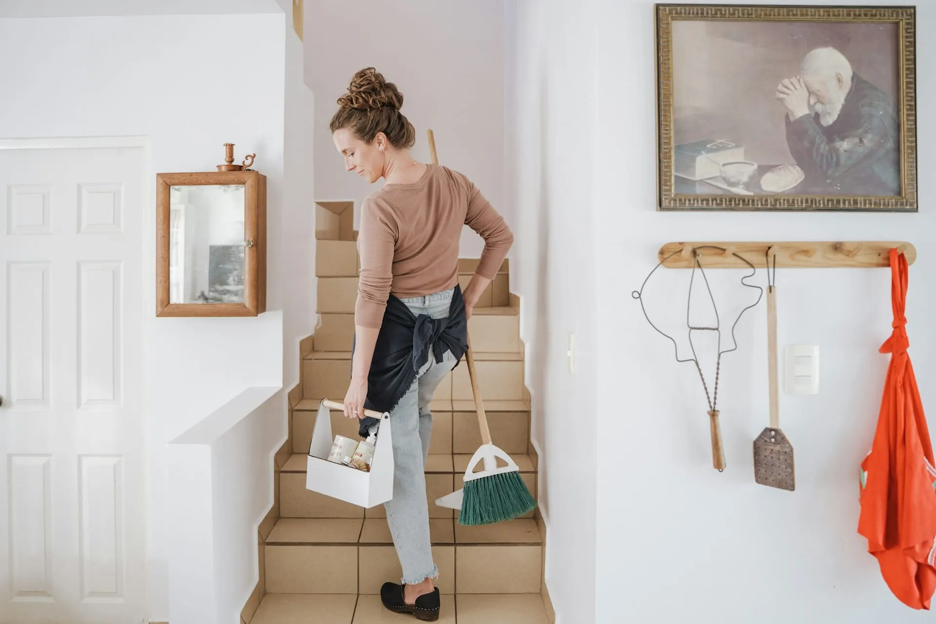 Cleaner carrying equipment up a communal staircase GK Cleaning Solutions Hove