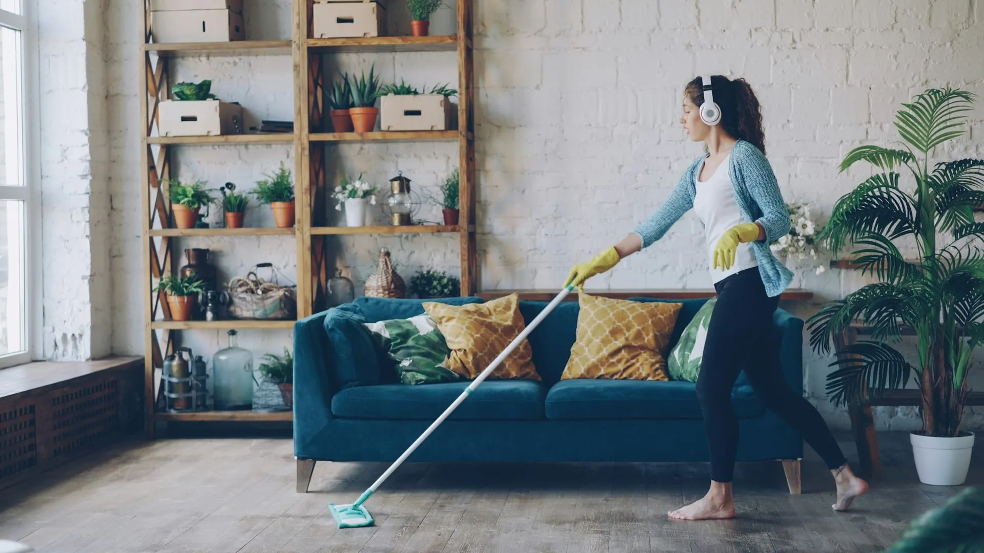 Cleaner mopping a living room floor during a regular clean GK Cleaning Solutions Hove